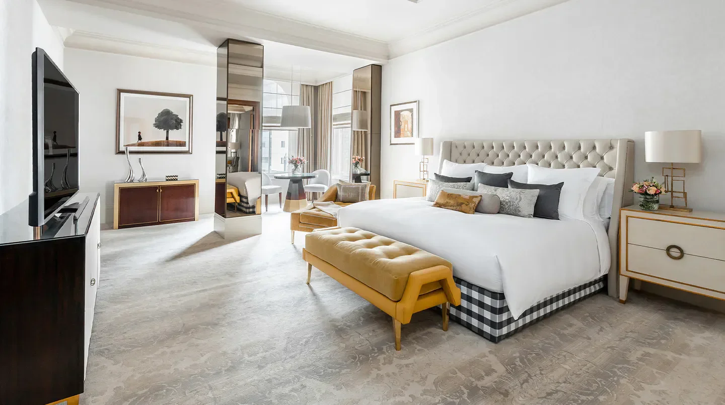 Elegant bedroom suite at The Langham, London hotel, showcasing luxurious design in London.