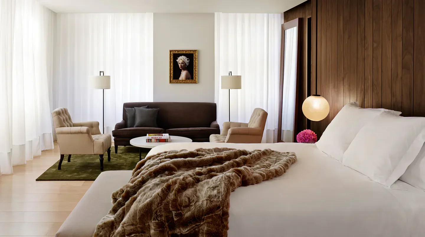Cozy bedroom at The London EDITION hotel, featuring luxurious bed and stylish decor in London.