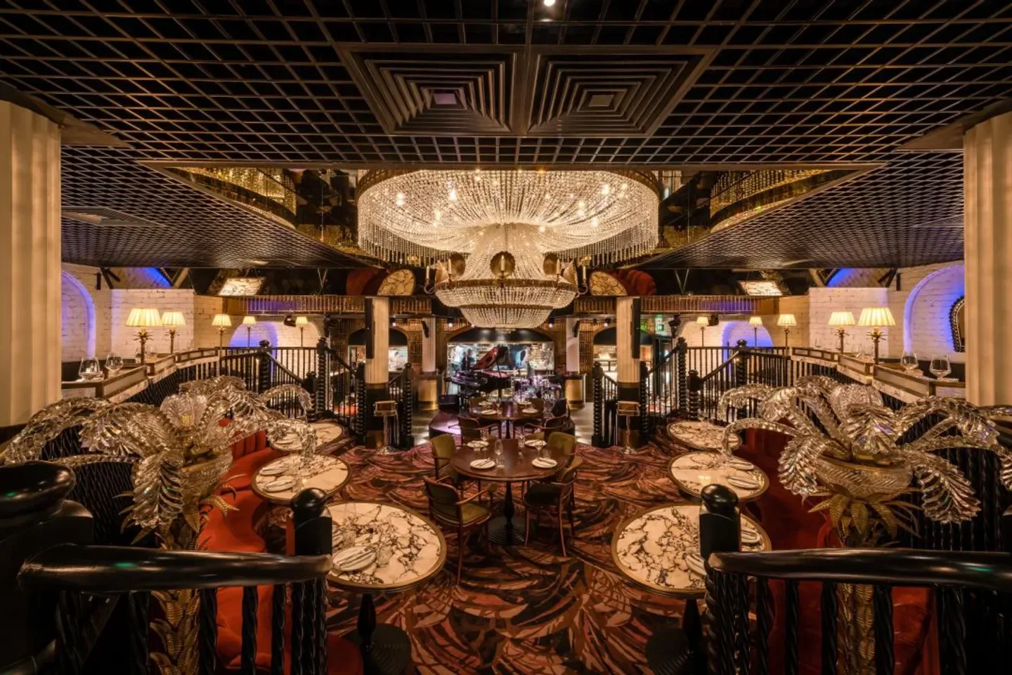 Elegant interior of The Maine Mayfair restaurant in London, featuring a stunning chandelier.
