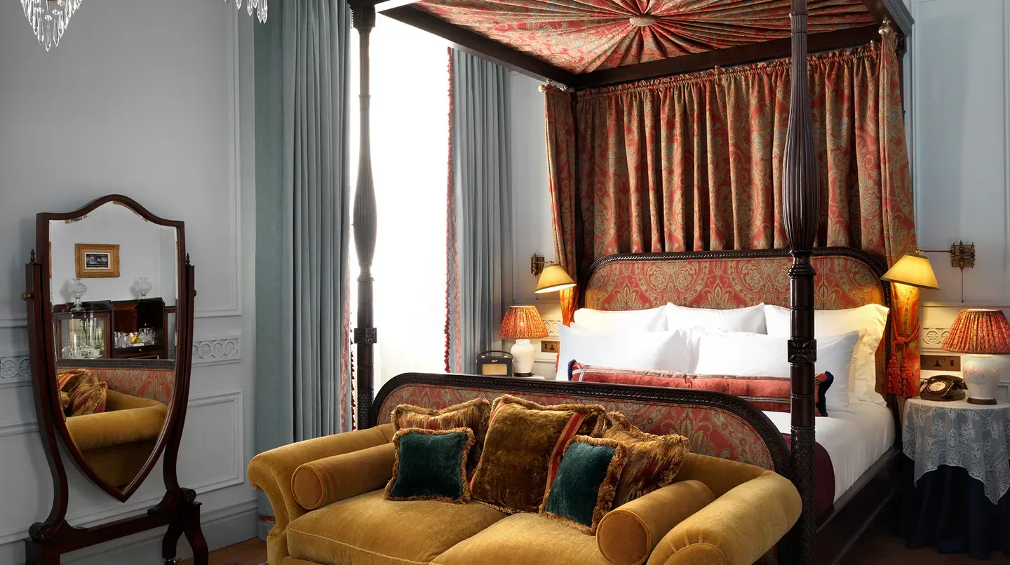Luxury bedroom interior at The Ned hotel in London, featuring a four-poster bed.