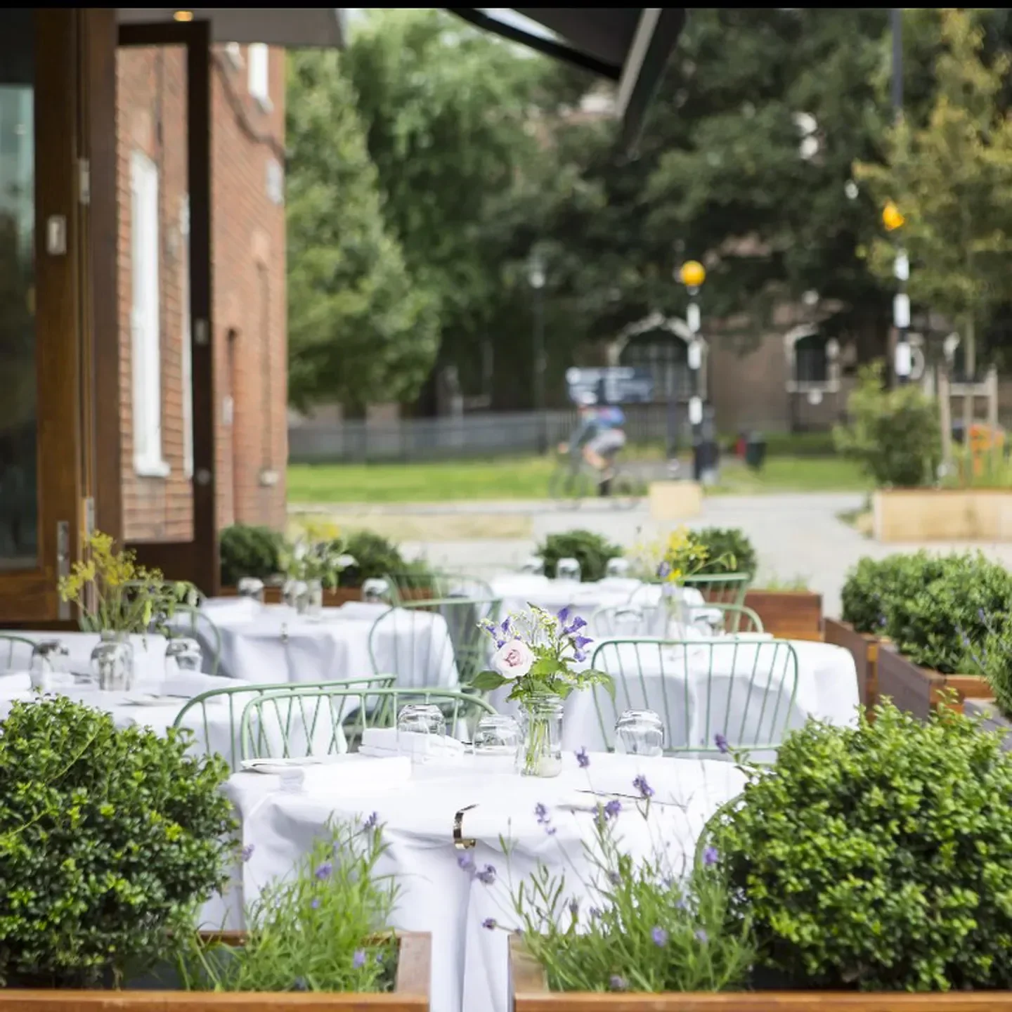 Outdoor seating at Trinity restaurant in London with tables set for dining.