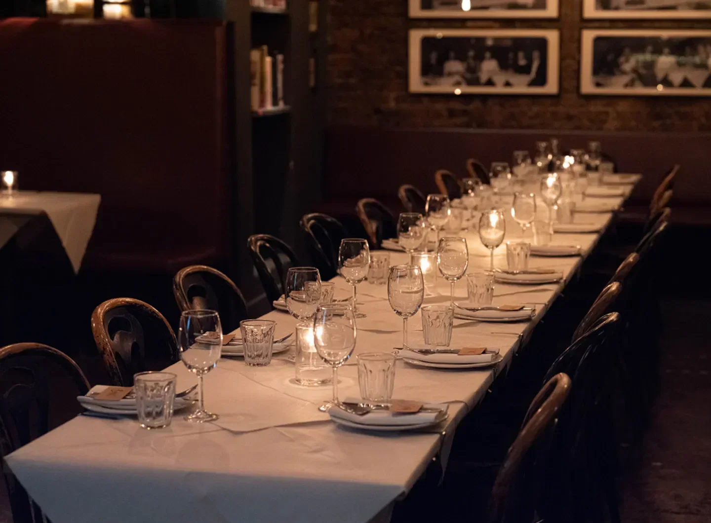 Elegant dining table set at Trullo restaurant in London, with candles and wine glasses.