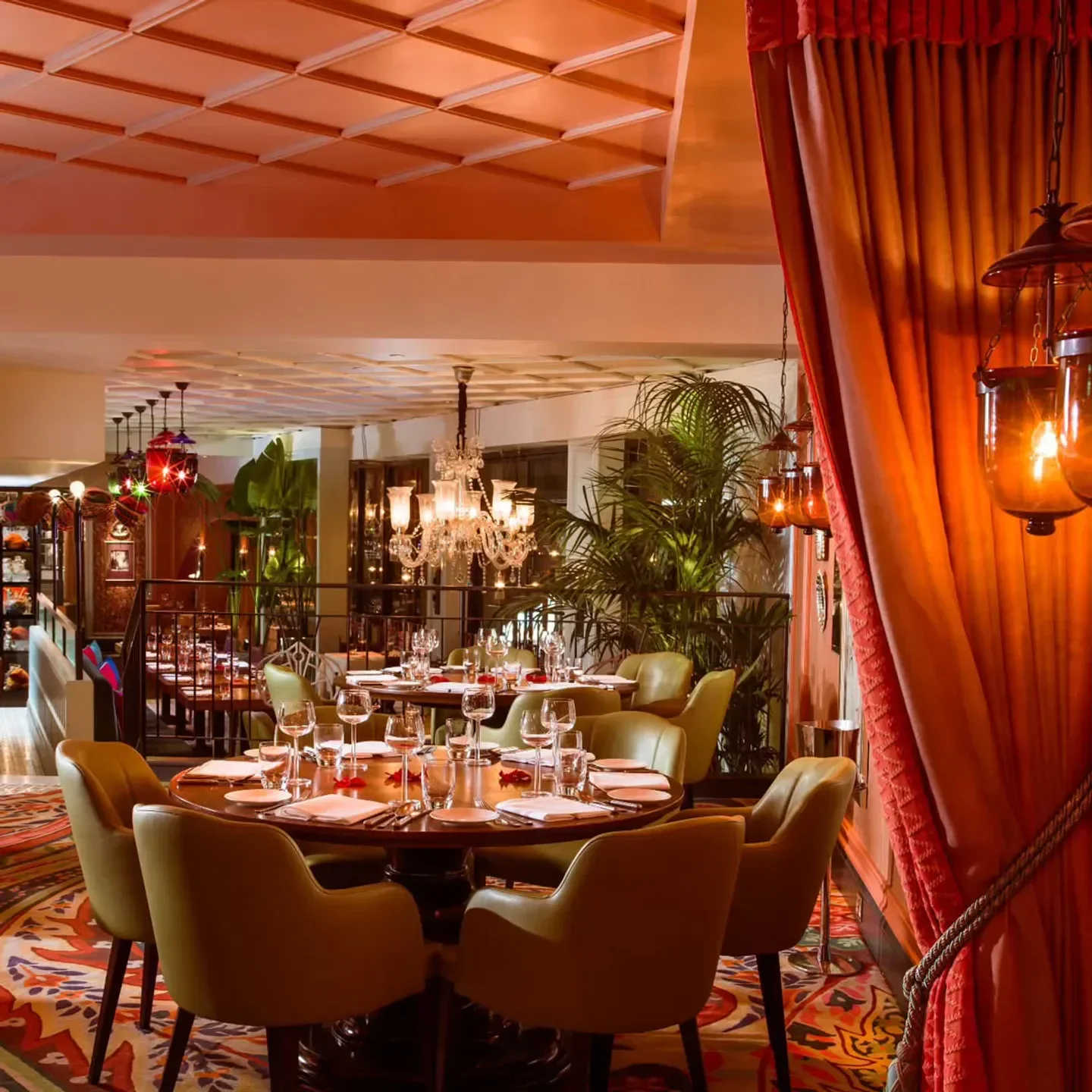 Elegant dining room at Veeraswamy in London, with warm lighting and chandeliers.